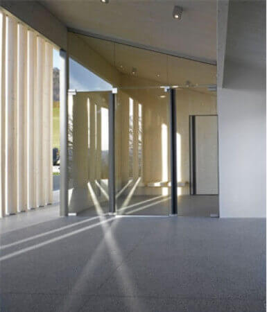 Sun beams entering through wooden columns in a modern designed cemetery building.