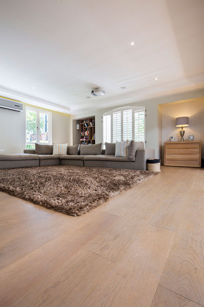 Wide plank hardwood floors in a living room.