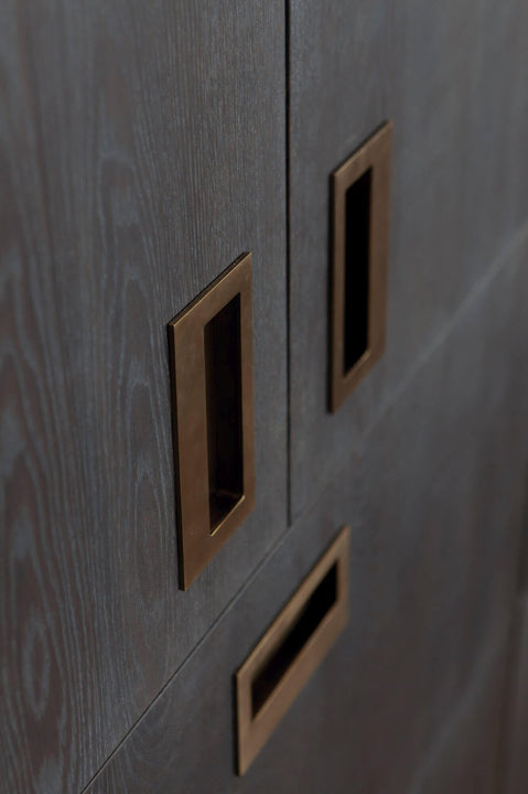 Flush mount dark brass drawer pulls.