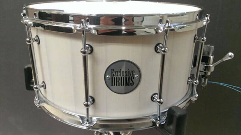 A custom wood drum with a white matte wood finish.