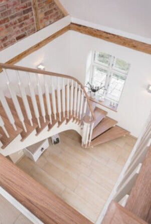 A staircase with a turn at the end and oak treads and handrail finished with Oil Plus 2C wood finish.