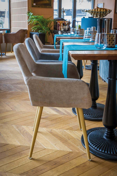 Chevron hardwood flooring in a restaurant with tables and chairs.