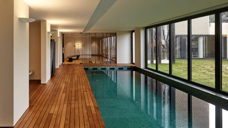 Indoor pool with teak wood deck finished with natural hardwax oil wood finish.