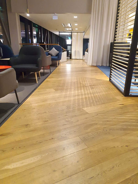Hardwood flooring inside of an airport lounge.