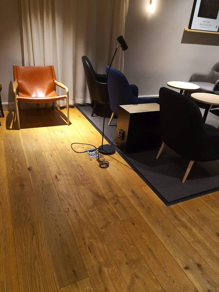 An airport lounge with hardwood flooring in it.