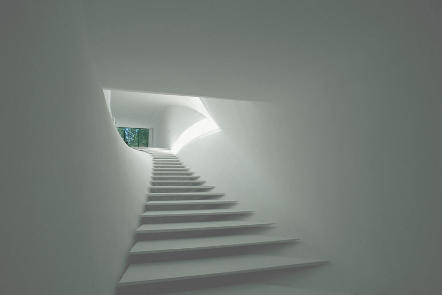 Clean white interior stairway.