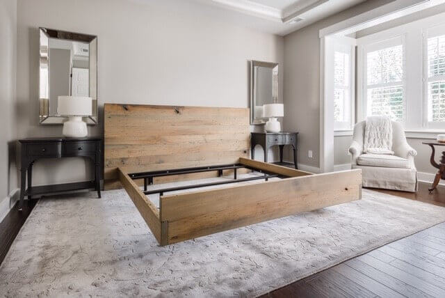 American Wormy Chestnut bed-frame in a master bedroom without mattress on it.