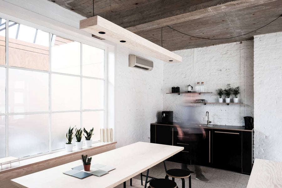 Architect office with white brick, plywood, and bold accents.