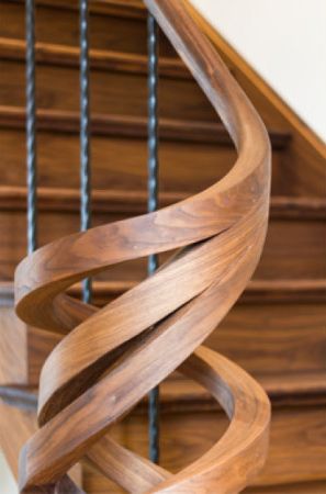 Hand rail detail on beautiful walnut wood stair case finished with Rubio Monocoat Oil Plus 2C.