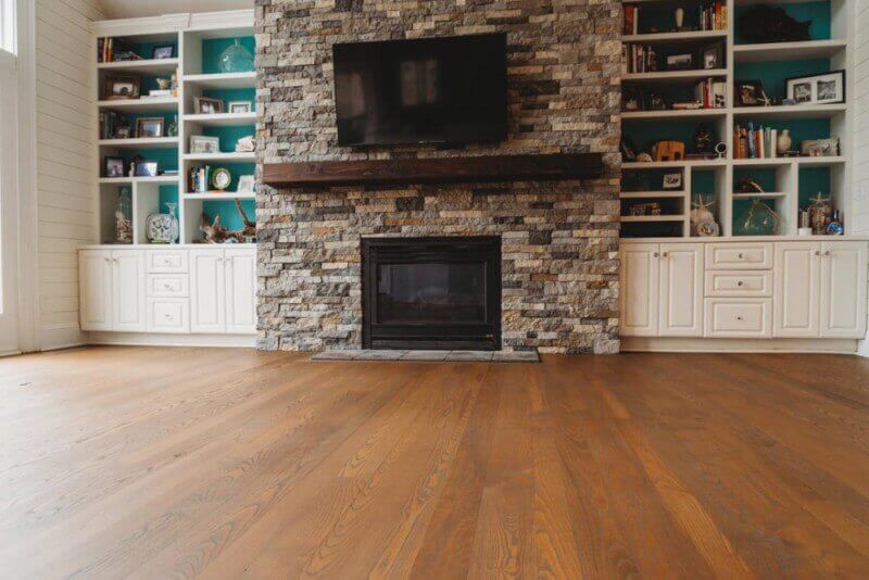 Fireplace in living room with hardwood floors finished with Rubio Monocoat.