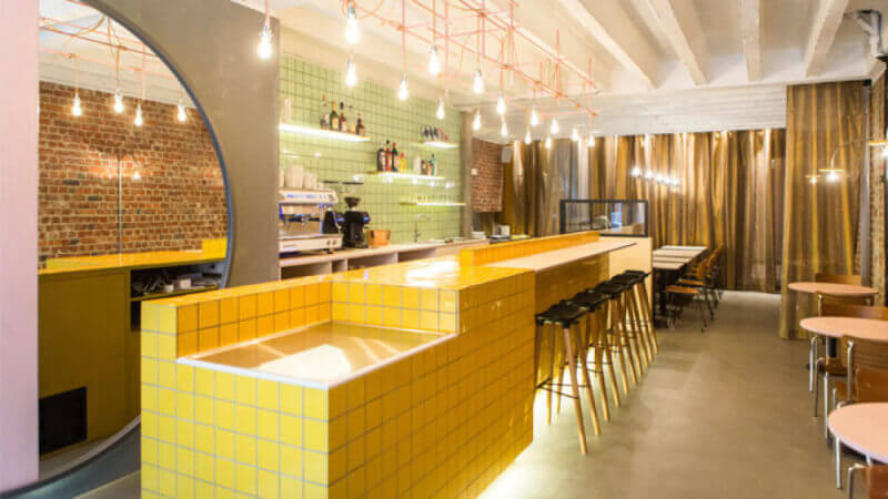 A bright yellow counter in a restaurant.