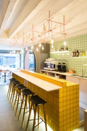 A restaurant bar counter made out of bright wood colors.