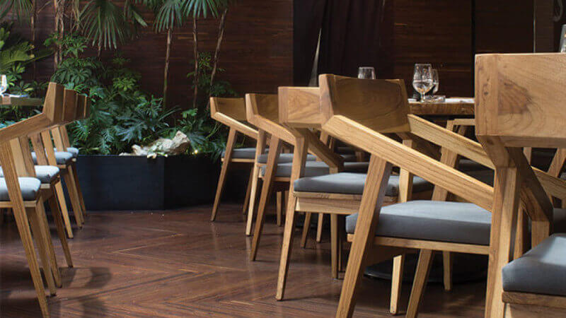 A line of wooden chairs in a restaurant finished with Rubio Monocoat Oil Plus 2C.