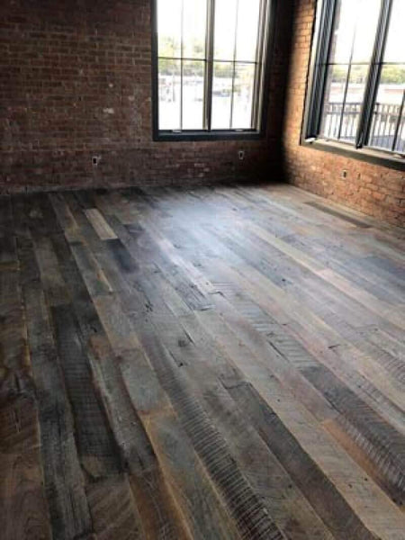 Hardwood with a rustic floor finish.