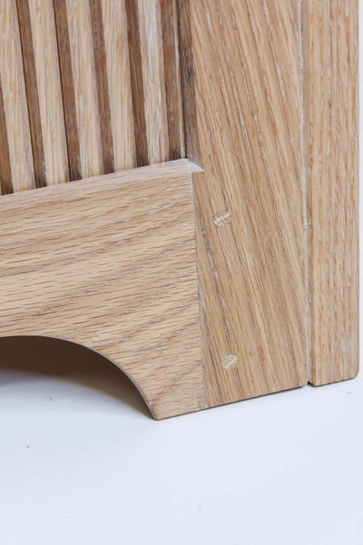Close up of the white oak dresser's curved base, reeded detail and drawbore mortise and tenons.