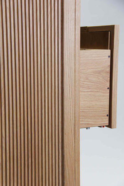 Side view of the reeded dresser with a drawer slightly extended, exposing the precise joinery of this white oak storage dresser finished with Rubio Monocoat Oil Plus 2C hardwax oil finish.