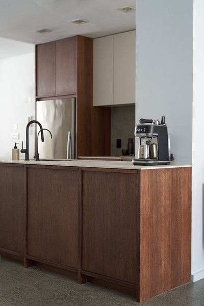 A contemporary modern kitchen complete with white oak lower cabinets finished with a brown wood finish and white upper cabinets.