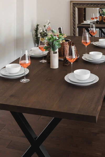 A white oak dining table with a metal X base finished with Rubio Monocoat Oil Plus 2C "Black".