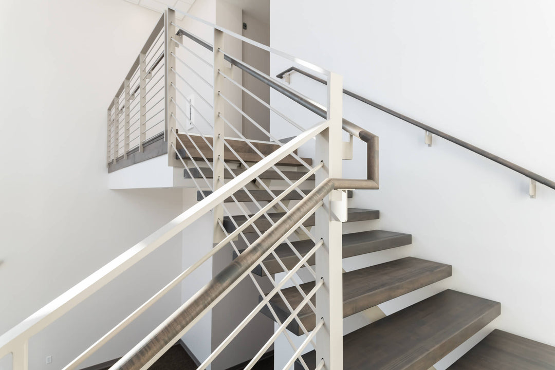 Custom stairwell in a leased office space made from maple wood and stained a cool grey tone with Rubio Monocoat products.
