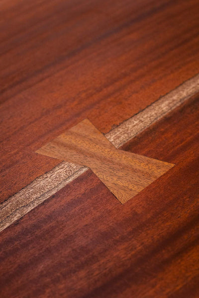 A bowtie inlaid in an African Mahogany tabletop.