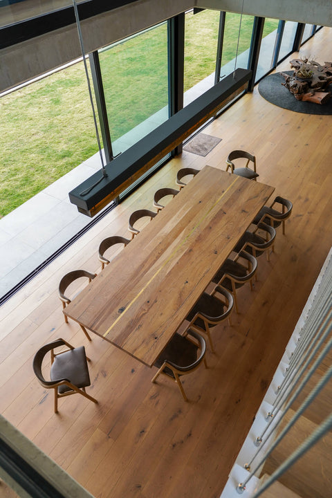 A large European oak table with enough seating for up to twelve people finished using Rubio Monocoat Oil Plus 2C hardwax oil wood stain and finish.