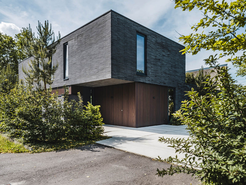 The exterior of a modern home fitted with thermally modified ash wood finished using DuroGrit exterior wood stain and finish in one.