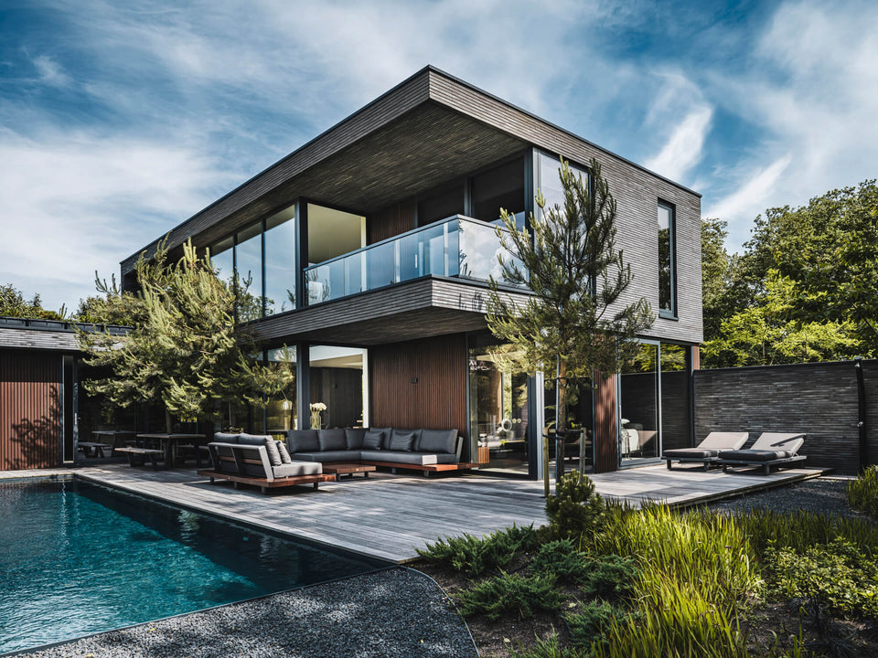 This contemporary home has a two-toned exterior featuring ash wood treated with DuroGrit Bison Brown.