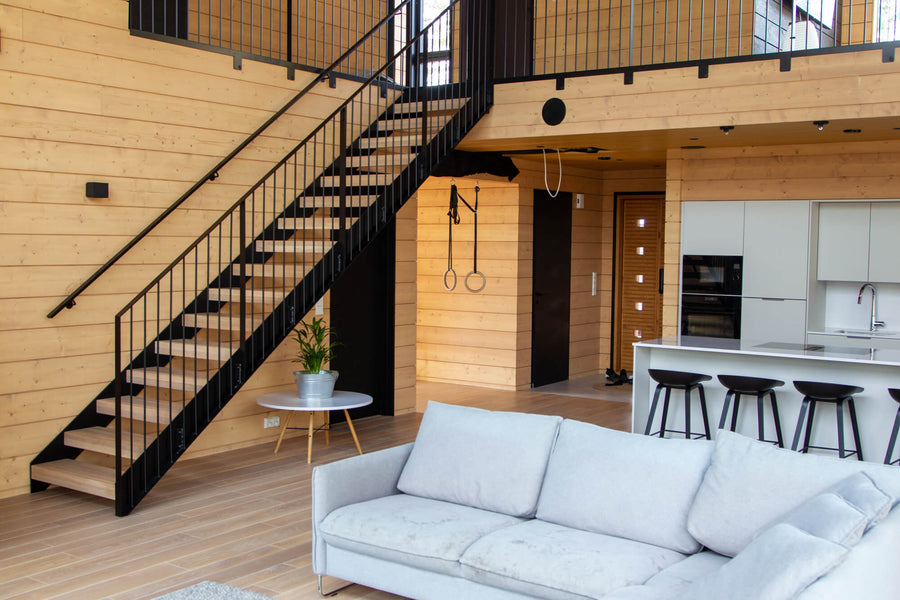 Stairs leading up to the upper level of an open concept home with spruce cladding throughout finished with Oil Plus 2C.