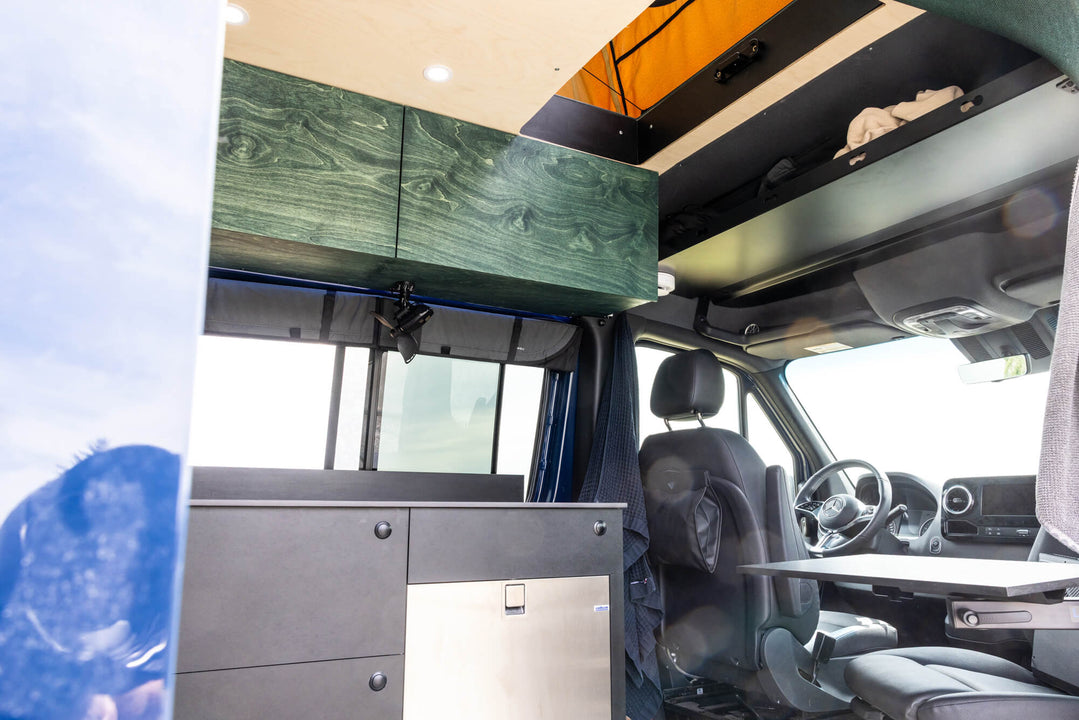 A custom sprinter van featuring birch cabinetry finished with Rubio Monocoat Oil Plus 2C "Fern".