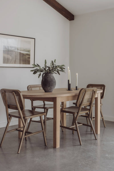 An oval-shaped white oak dining table finished with Rubio Monocoat Oil Plus 2C hardwax oil wood stain and finish in the colour "Mist 5%".