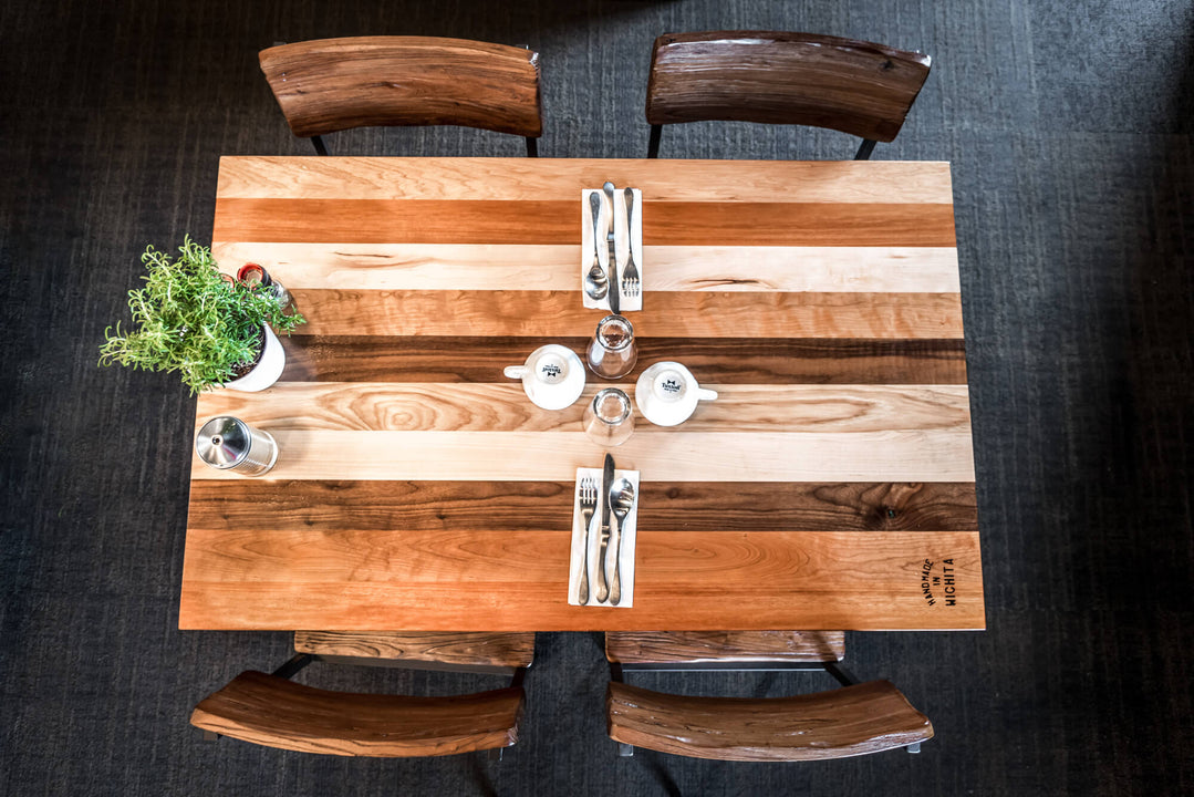 An aerial view of a restaurant table made from several different wood species and finished using Rubio Monocoat Oil Plus 2C hardwax oil wood stain and finish for interior wood projects.