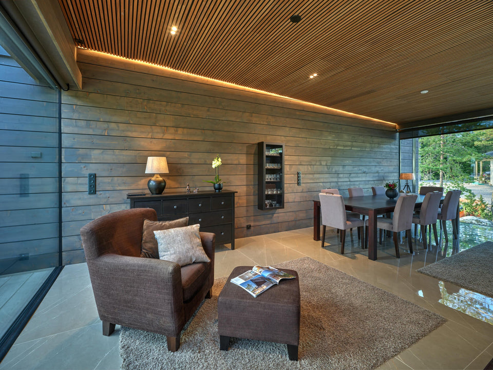 A living and dining area fit with spruce cladding finished with Rubio Monocoat Precolor Easy Cashmere Brown and Oil Plus 2C Oyster.