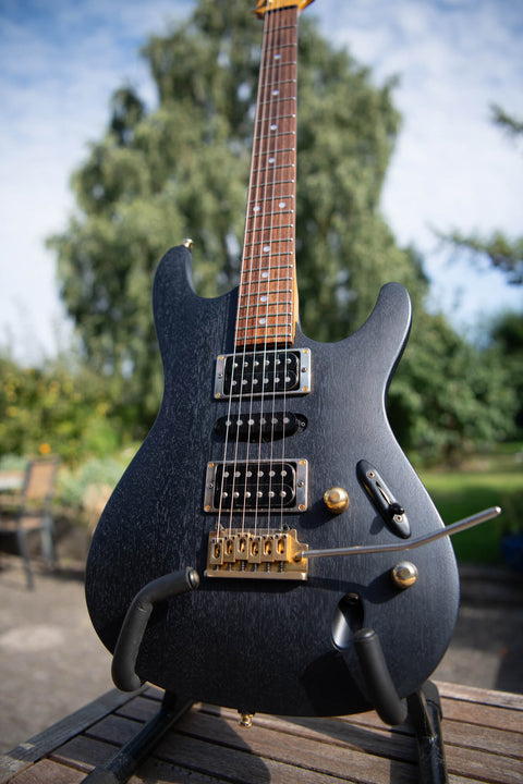 A mahogany Ibanez guitar was refinished with Rubio Monocoat Precolor Easy Intense Black and Oil Plus 2C Midnight Sky for a sleek look with a blue leaning hue.