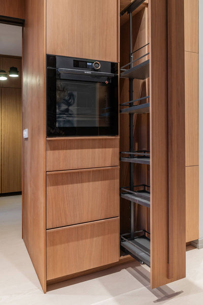 Oak kitchen cabinetry finished with Rubio Monocoat Oil Plus 2C "Mist 5%" featuring a pullout shelf and built-in oven.