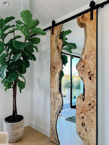 Stunning mappa burl slabs holding a mirror that is also a sliding door. The wood is finished with Oil Plus 2C hardwax oil wood finish for interior use.