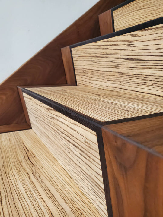 Up close of stairs made from zebra wood, wenge and black walnut finished with a hardwax oil wood finish.