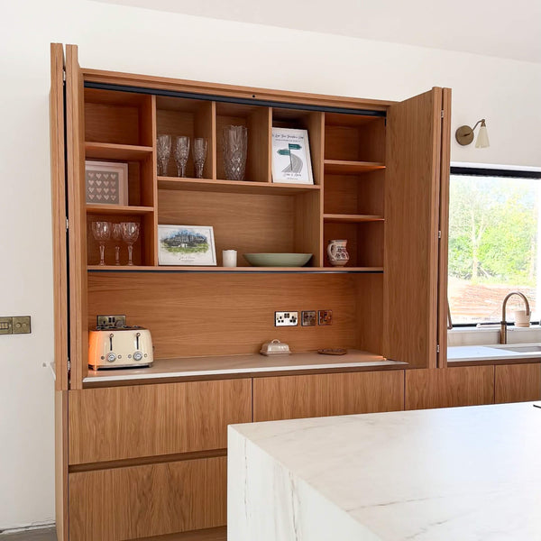 Accordion hinged oak cabinet doors finished with Rubio Monocoat Oil Plus 2C hardwax oil wood finish.