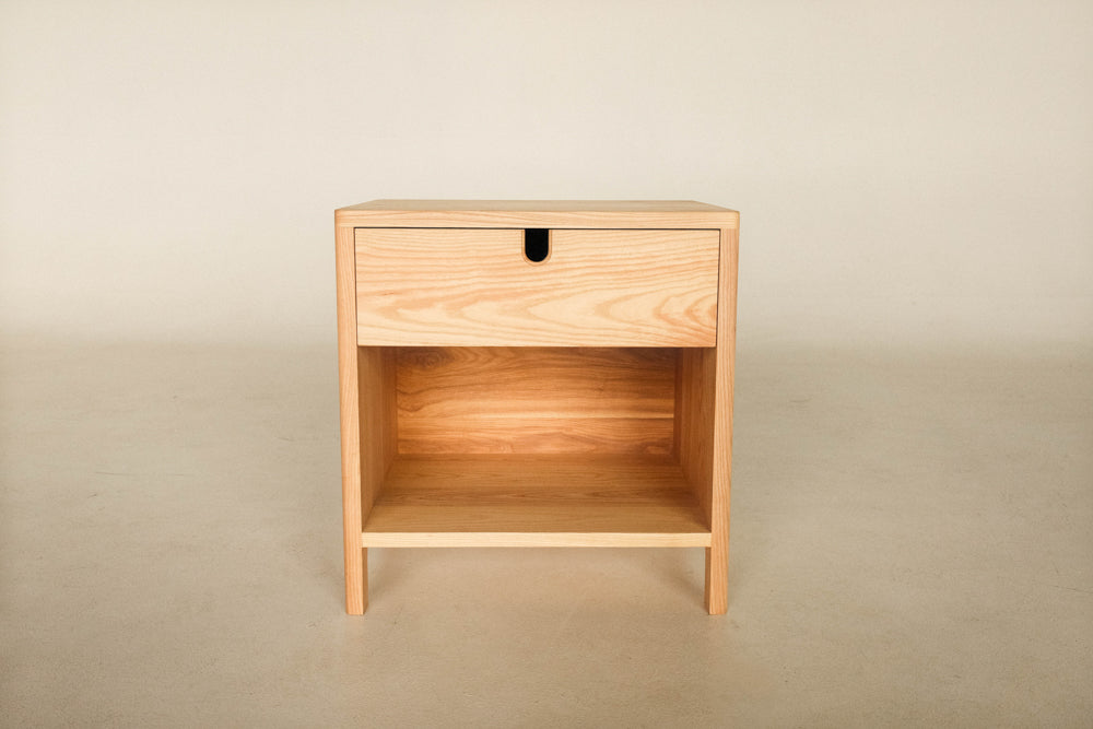 A nightstand with a lower shelf and an upper drawer made from ash and finished with Oil Plus 2C hardwax oil wood finish.