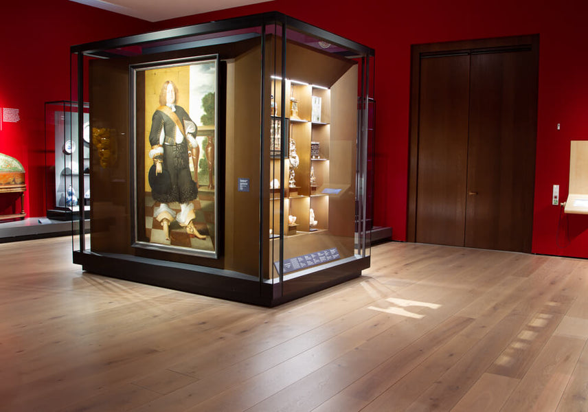 A display at the Norwegian National Museum in an area with red painted walls and light hardwood flooring finished with Oil Plus 2C hardwax oil wood finish.