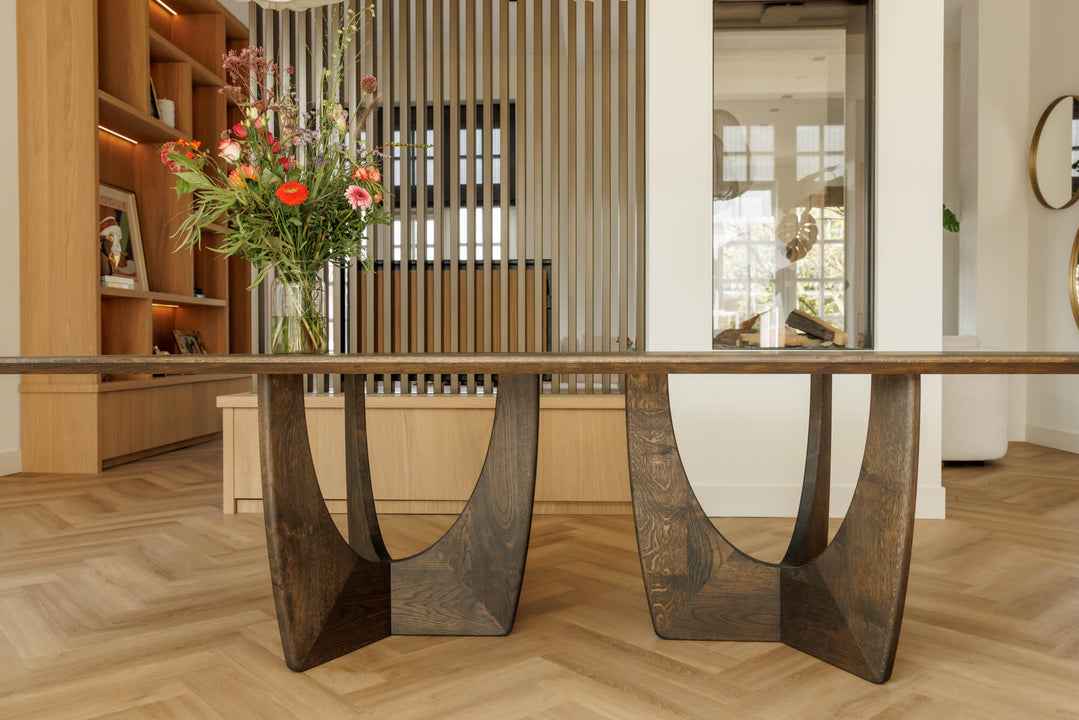 A modern dining table with a unique base made from European oak and finished with Oil Plus 2C "Black".