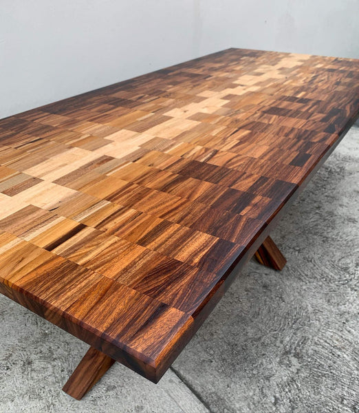 An ombre-inspired dining table top made from a variety of exotic wood species.