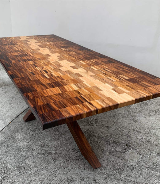 A custom wood dining table made from several different wood species finished with Oil Plus 2C hardwax oil.
