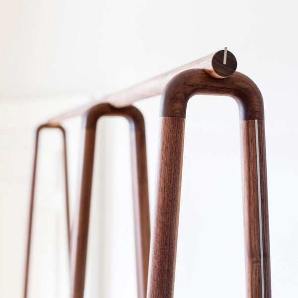 Modular racks of an open walnut wardrobe.