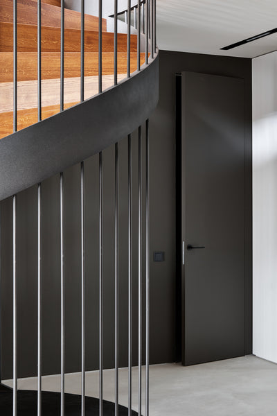 Detail on the metal railing on a spiral staircase.