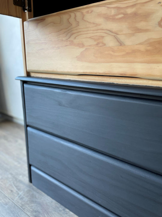 The lower half of a pine armoire featuring a two-toned finish using Rubio Monocoat products.
