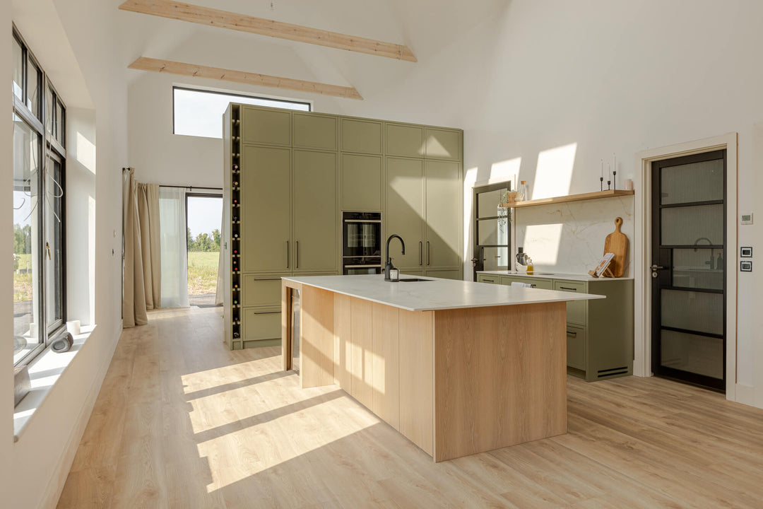 A small, cozy kitchen with light green cabinetry with contrasting wood island and wood floating shelf finished with Oil Plus 2C "Smoke".