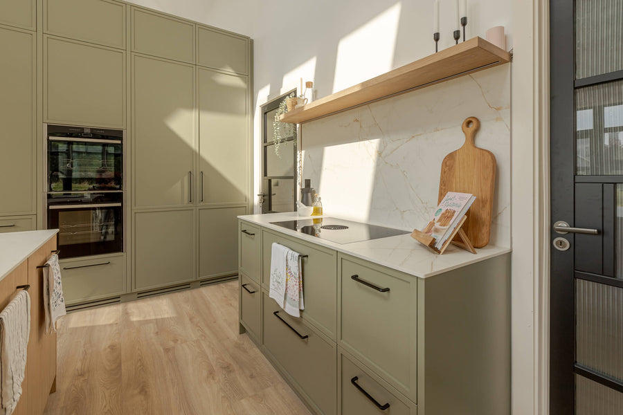 Light green cabinetry with oak accents finished with Oil Plus 2C "Smoke" to color and protect them.