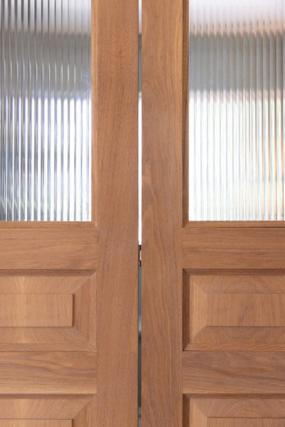 Two white oak doors with reeded glass finished with Rubio Monocoat Oil Plus 2C.