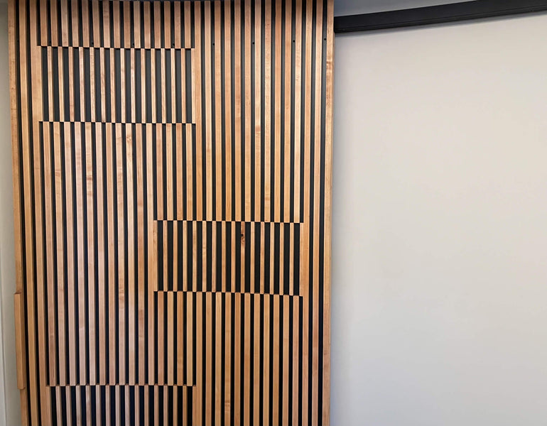 A curved, slatted door made from maple wood.