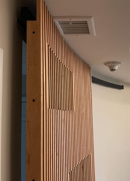 A curved door with maple slats on it finished with Rubio Monocoat.